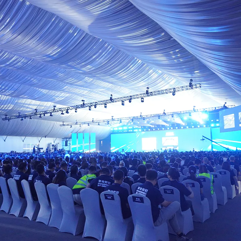 Large clear span exhibition tent hosting an outdoor international trade show